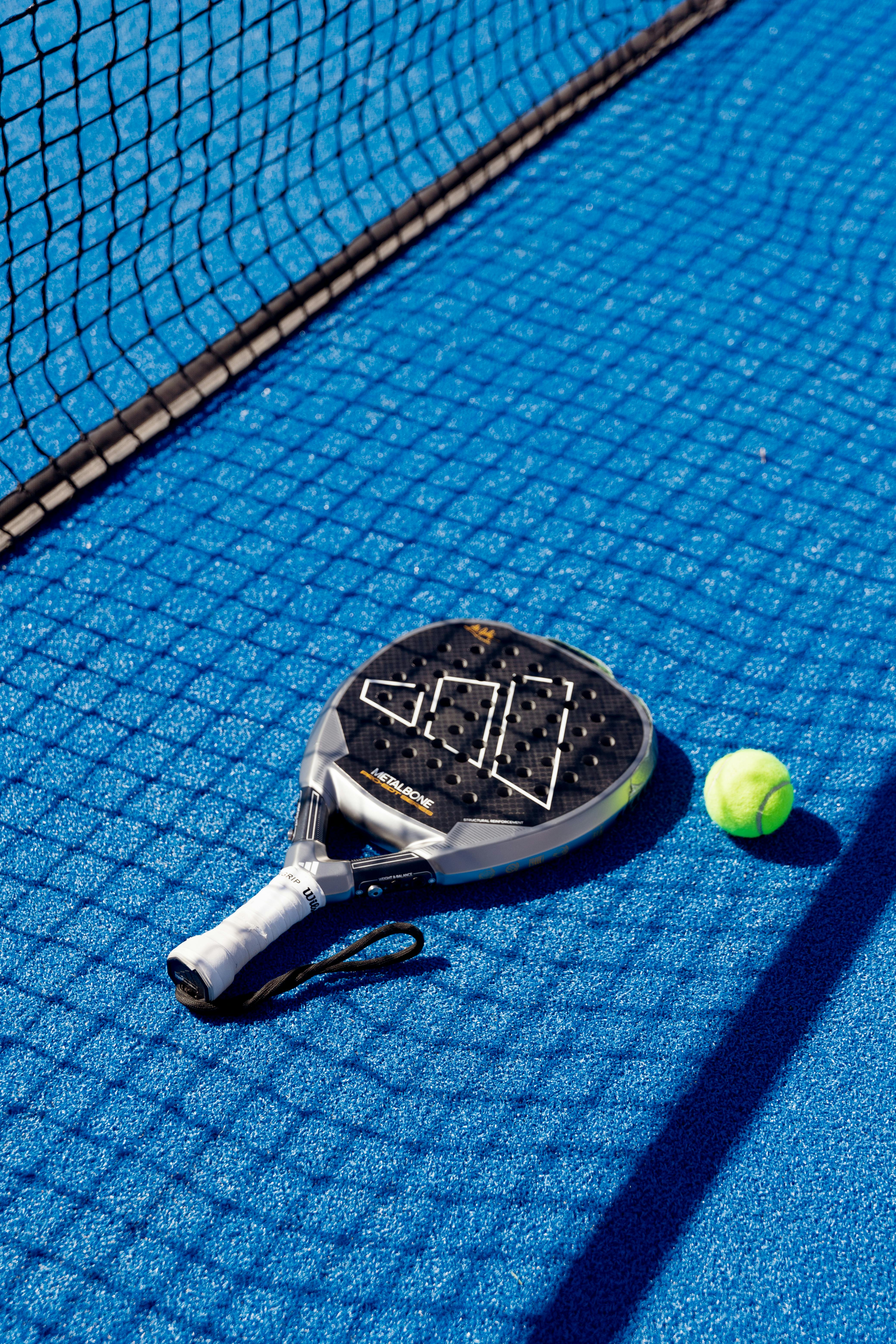 Two padel players practising a drill together on court